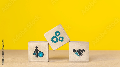 Concrete cubes, blocks on a yellow background. Business strategy and action plan concept. With copy space