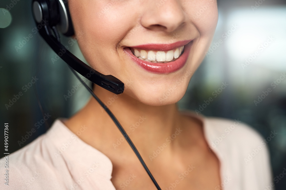 Shes standing by to take your call. Cropped shot of a young call centre agent working in an office. Shes standing by to take your call. Cropped shot of a young call centre agent working in an office.