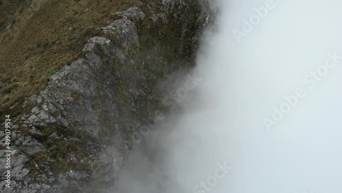 Aerial View of Steep Hills and Dense Clouds Under Rucu Pichincha Volcano Ecuador - Drone Shot
