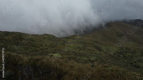 Aerial View of Green Hills and Plateau Under Clouds and Rucu Pichincha Volcano, Quito, Ecuador - Drone Shot