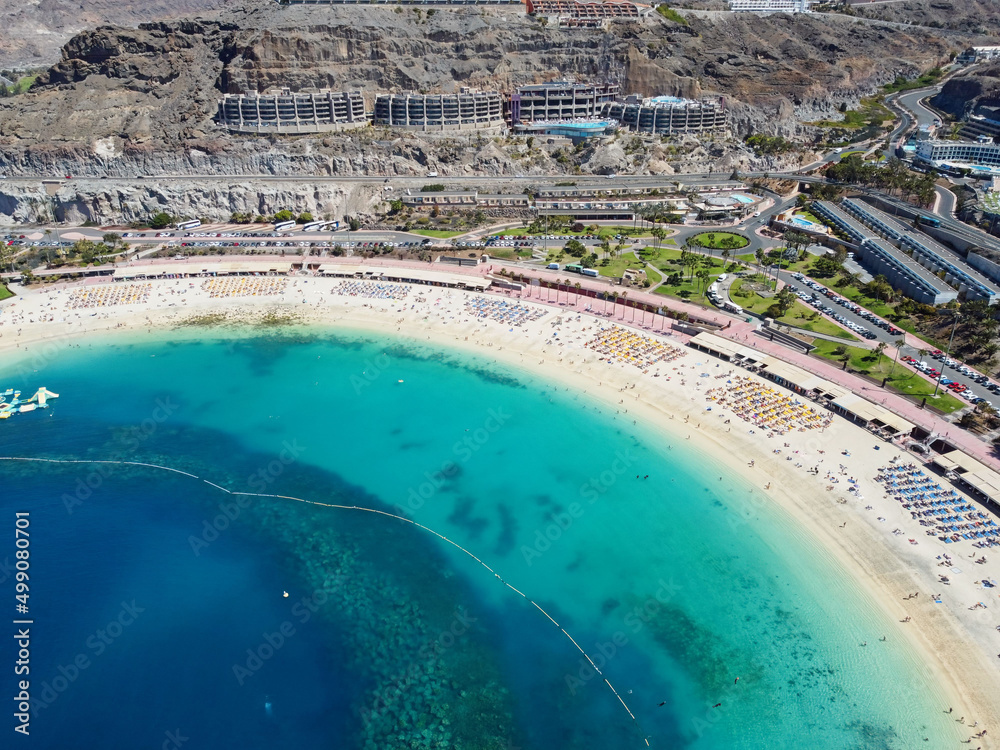 Aerial drone photo. Playa de Amadores, large cove with a white sand beach. Puerto Rico de Gran Canaria, Canary Islands, Spain.