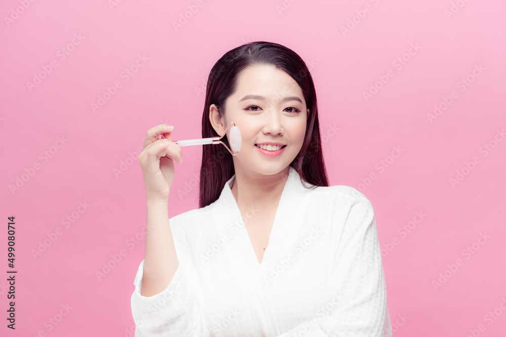 Woman caring of her beauty face with cosmetic tool. Skin care concept. Girl holds item for makeup. Woman caring of her beauty face with cosmetic tool. Skin care concept. Girl holds item for makeup.