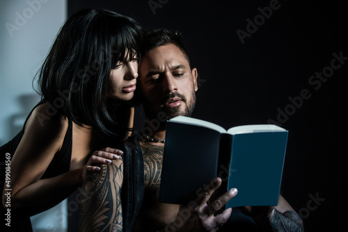 Sexy couple reading book. Romantic lovely coupl in love, sexy boyfriend and beautiful girlfriend. Romantic lovers.