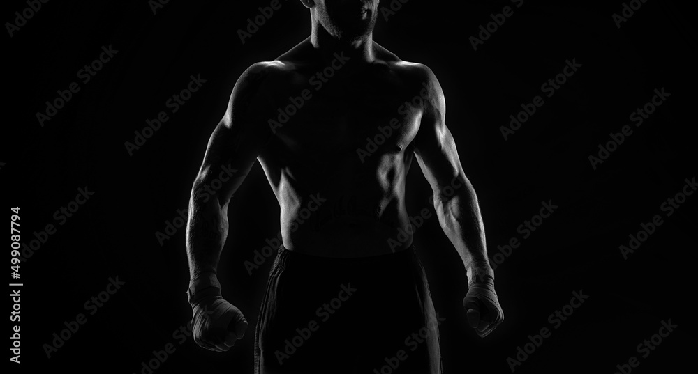 Noname image of a kickboxer on a dark background. The concept of mixed martial arts. Noname image of a kickboxer on a dark background. The concept of mixed martial arts.