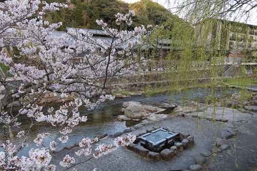 The view of a  foot bath at Gangi-hiroba Square on Otozure-gawa River flowing through Nagato-yumoto Town with hot springs in Yamaguchi Prefecture in Japan 日本の山口県長門市にある温泉町の長門湯本を貫流する音信川沿いの雁木広場にある足湯 photo