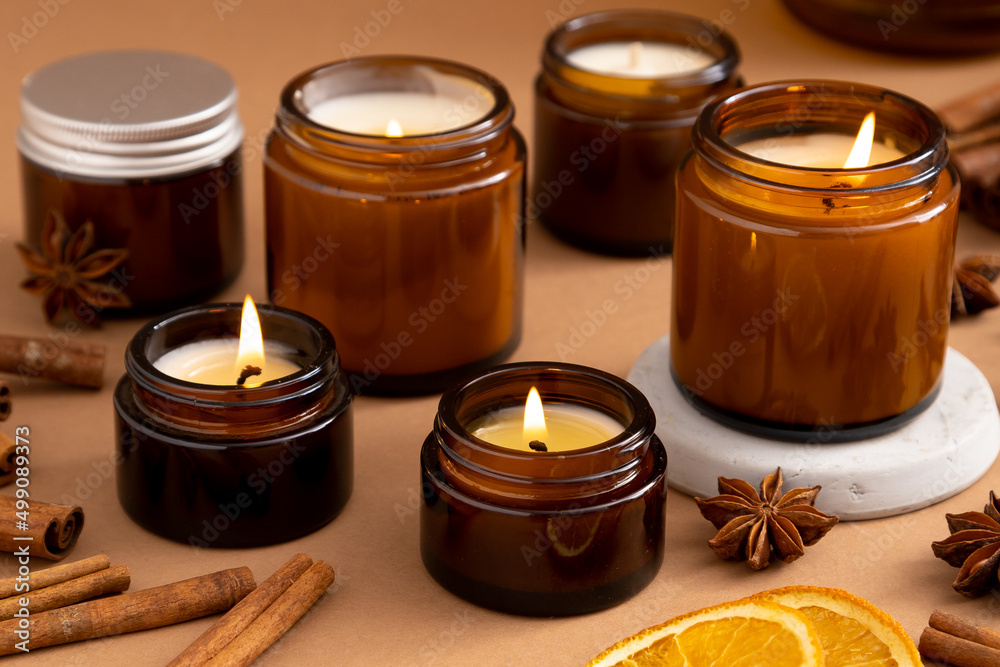 A set of different aroma candles in brown glass jars. Scented handmade  candle. Soy candles are burning in a jar. Aromatherapy and relax in spa and  home. Stock Photo | Adobe Stock