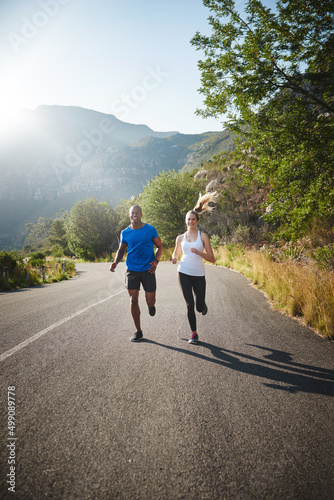Were in it for the long run. Shot of a sporty couple out running on a mountain road.