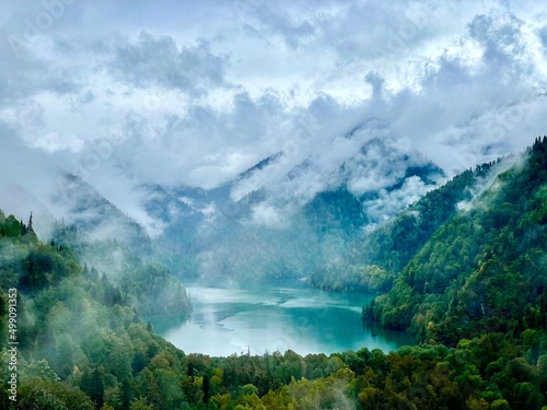 Lake Ritsa on beautiful mountains landscape in Abkhazia or Georgia photo and sky clouds nature in early autumn wallpaper