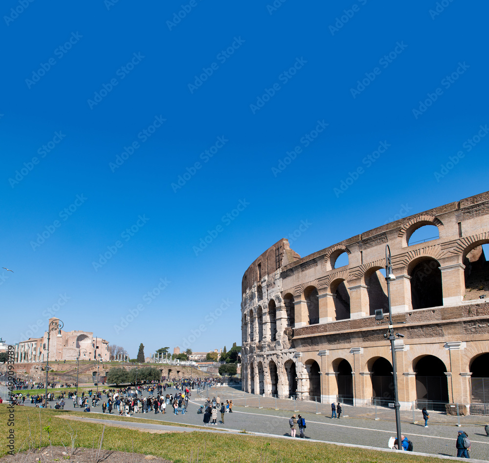 Colosseum external view large group of tourists people, copy space on blue sky on top, Rome Italy