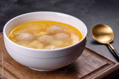 Soup with turkey meatballs, potatoes and vegetables. Selective focus