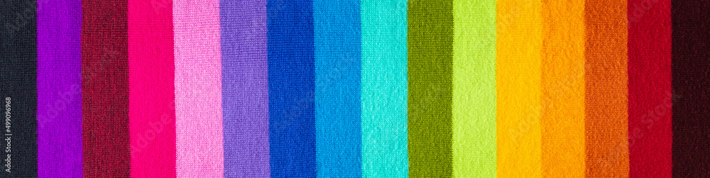 Fototapeta premium multi colored background. knitted wool fabric texture with rainbow stripes