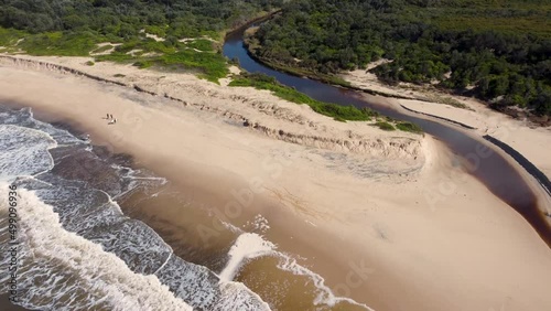 Aerial drone scenic landscape shot of Catherine Hill Bay channel on Pacific Ocean beach with people surfers waves Newcastle Central Coast NSW Australia 4K photo