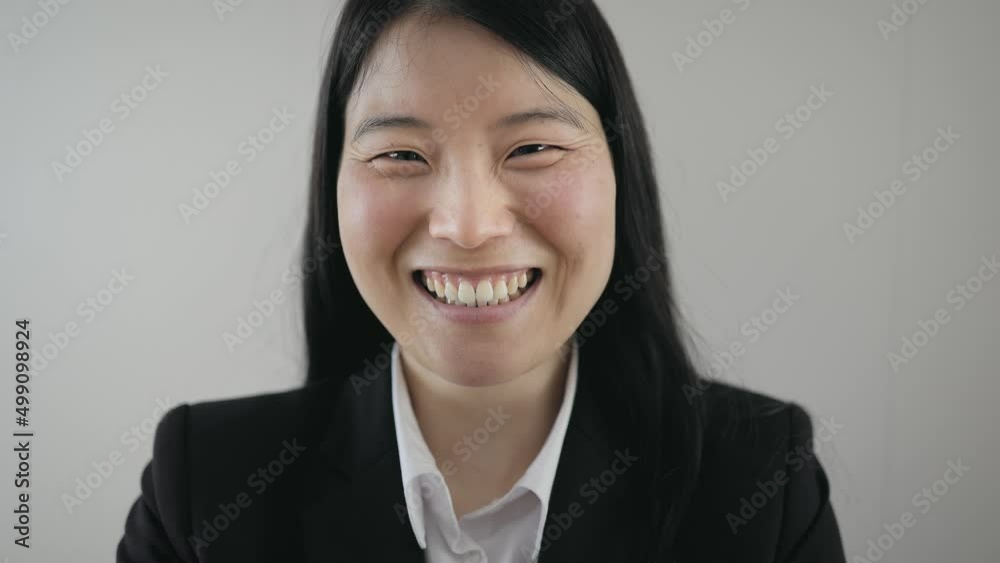 Happy Asian business woman smiling in camera Happy Asian business woman smiling in camera