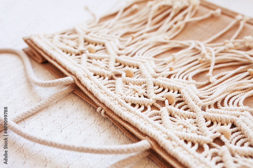Handmade jute shopping bag with macrame decor. Eco bags for women from Jute and cotton rope. Scandinavian style shopper. Beige tones, sustainable fashion accessories. Zero waste lifestyle. Handmade jute shopping bag with macrame decor. Eco bags for women from Jute and cotton rope. Scandinavian style shopper. Beige tones, sustainable fashion accessories. Zero waste lifestyle.