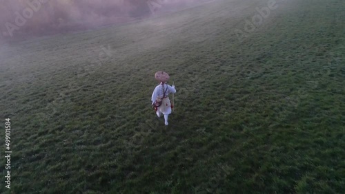 European buddhist shugendo monk walks in sunrise and fog and makes ceremony in nature