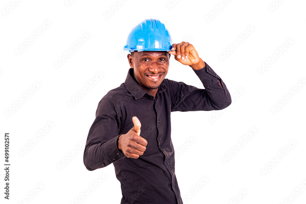 young man engineer wearing safety helmet and showing his thumb smiling. young man engineer wearing safety helmet and showing his thumb smiling.