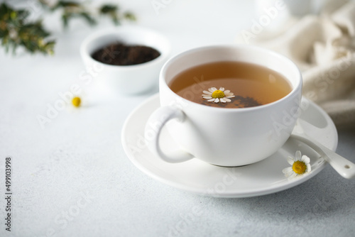 Healthy homemade chamomile tea in a white cup