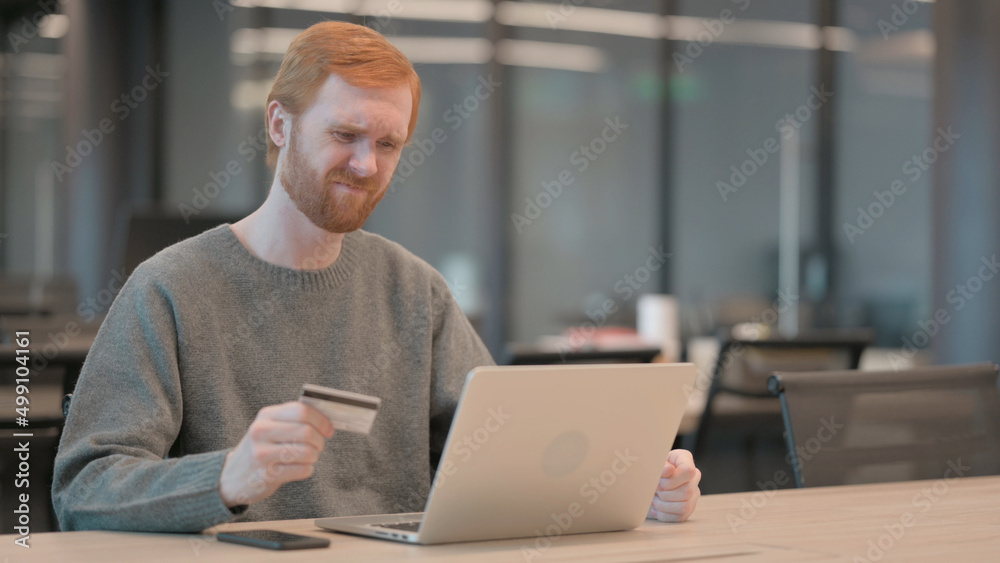 Young Man making Online Payment Failure on Laptop in Office Young Man making Online Payment Failure on Laptop in Office