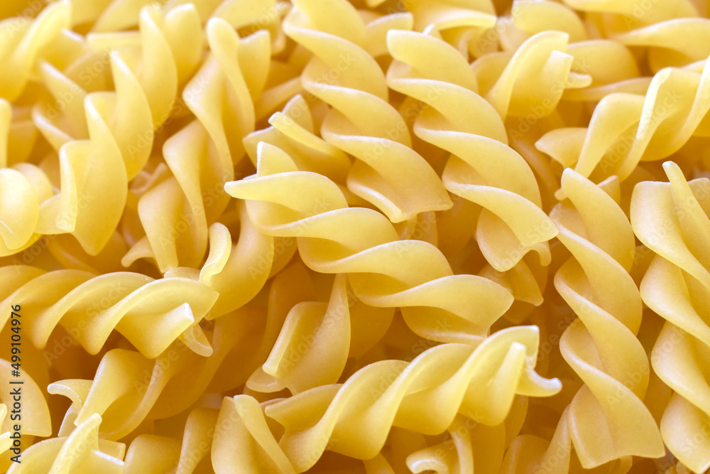 Fusilli pasta texture background. Italian pasta background. Fusilli pasta texture background. Italian pasta background.