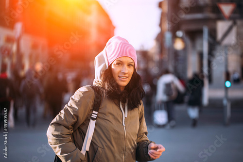 Portrait of a happy smiling woman standing in the square on a sunny summer or spring day outdoors, lovely smiling