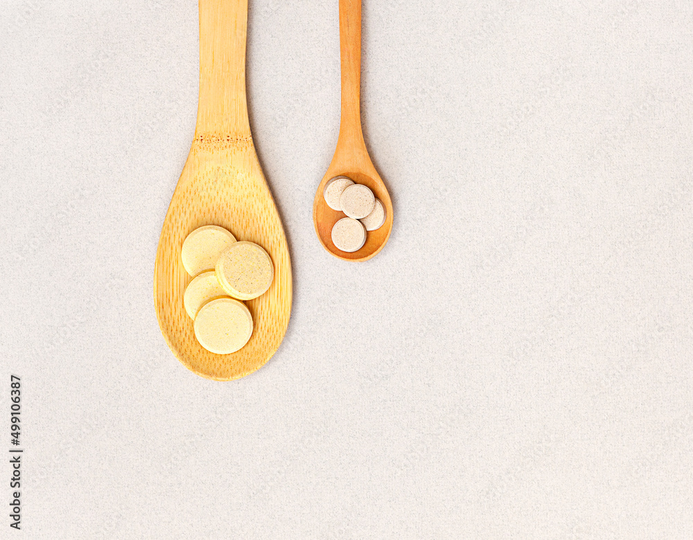 two wooden spoons with pills on the table. View from above two wooden spoons with pills on the table. View from above