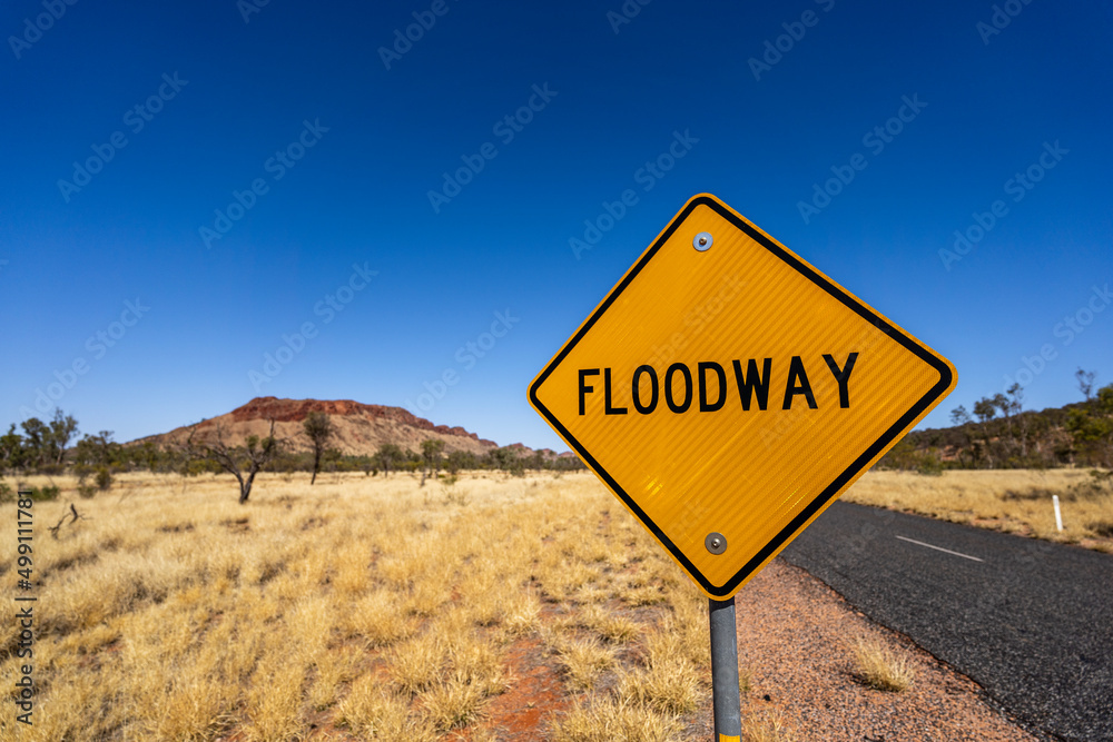 Flood warning sign on outback Australian road. Alice Springs, Northern Territory. Flood warning sign on outback Australian road. Alice Springs, Northern Territory.