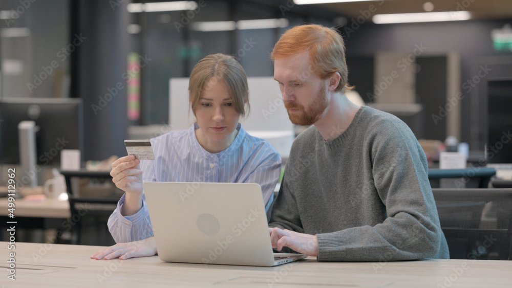 Fototapeta premium Young Man and Woman Making Online Payment on Laptop 