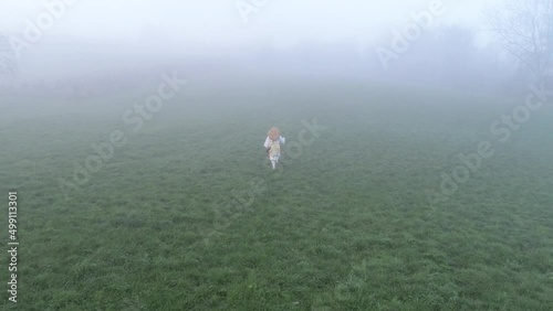 European buddhist shugendo monk walks in sunrise and fog and makes ceremony in nature photo