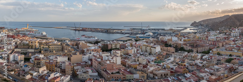 Panoramic view of downtown Almeria, with residential area and port area, commercial port with containers and cruise boats and ferry, mediterranean sea , Almeria , Spain