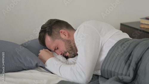 Man Crying while Sleeping in Bed