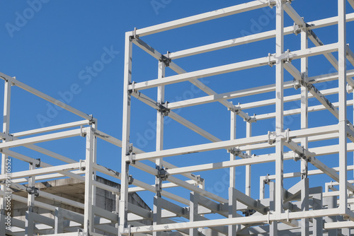 construction of a building. metal framework of a new house on blue sky background. architecture concept