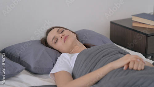 Relaxed Woman Sleeping in Bed Peacefully  © stockbakers