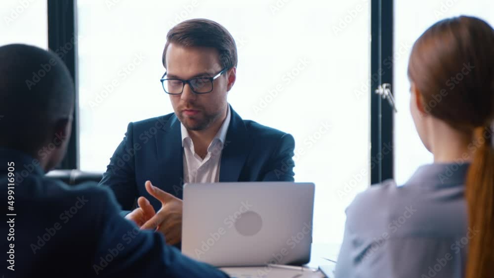 Young director giving new ideas about the project to his business partners Young director giving new ideas about the project to his business partners