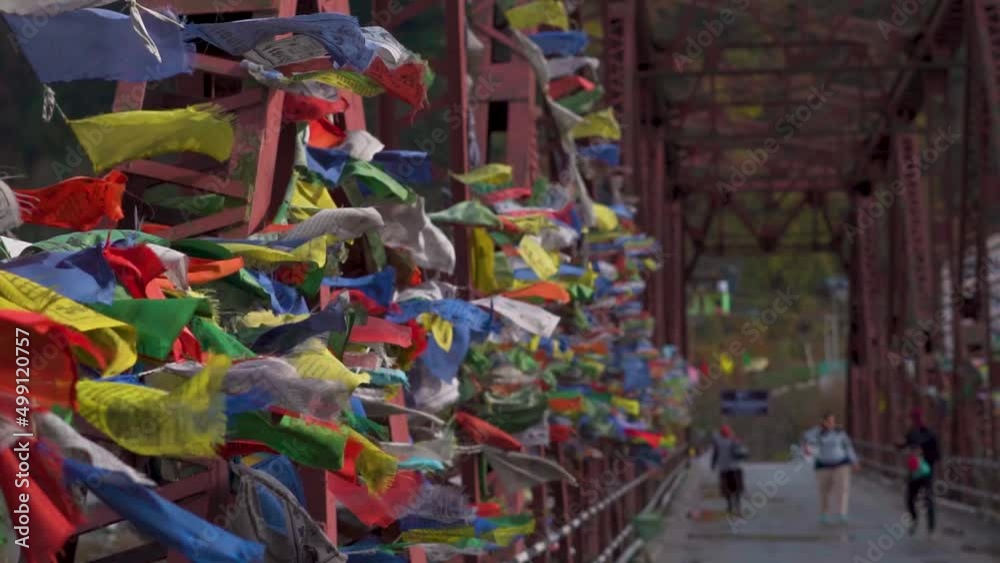 Closeup Slow motion shot of Buddhist prayer flags on a bridge waving on the wind at Manali in Himachal Pradesh, India. Closeup Slow motion shot of Buddhist prayer flags on a bridge waving on the wind at Manali in Himachal Pradesh, India.