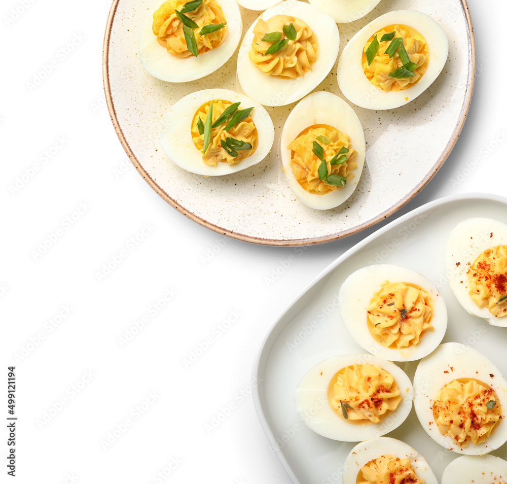 Plates with tasty stuffed eggs on white background. Easter celebration Plates with tasty stuffed eggs on white background. Easter celebration