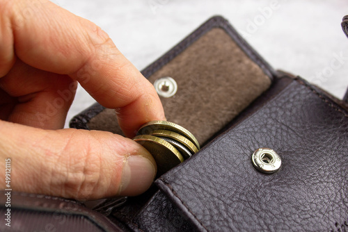 Money in the wallet. Coins in the wallet. Metal coins.