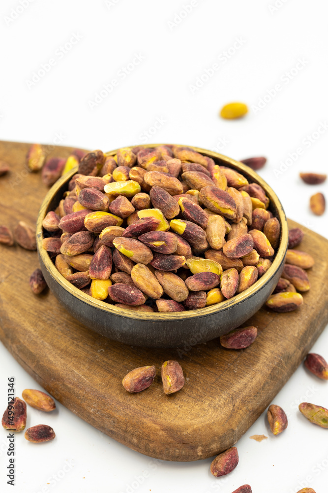 Pistachio kernel isolated on white background. A bowl of pistachios. close up Pistachio kernel isolated on white background. A bowl of pistachios. close up