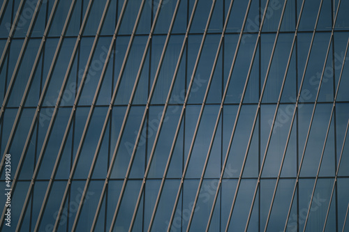 blue glass wall of skyscraper