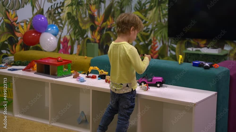 Boy playing with cars indoors Boy playing with cars indoors