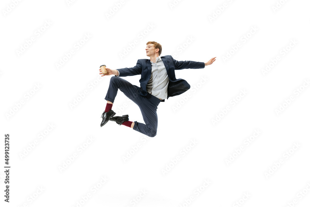 Portrait of flexible man in business style clothes dancing isolated on white studio background. Business, start-up, open-space, inspiration concept.