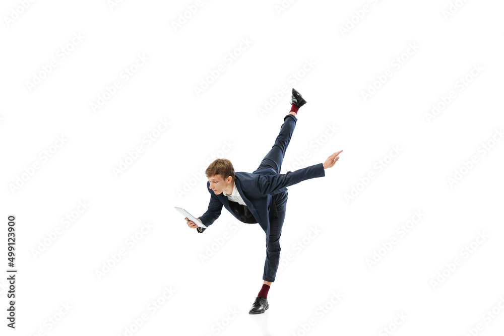 Man in office style clothes dancing and using tablet isolated on white studio background. Business, start-up, open-space, inspiration concept. Man in office style clothes dancing and using tablet isolated on white studio background. Business, start-up, open-space, inspiration concept.