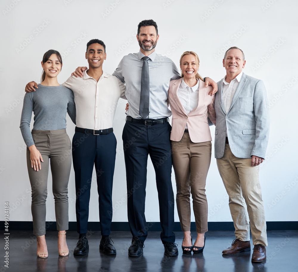 Obraz premium Its a great day to expand the team. Shot of a group of businesspeople standing in an office at work.