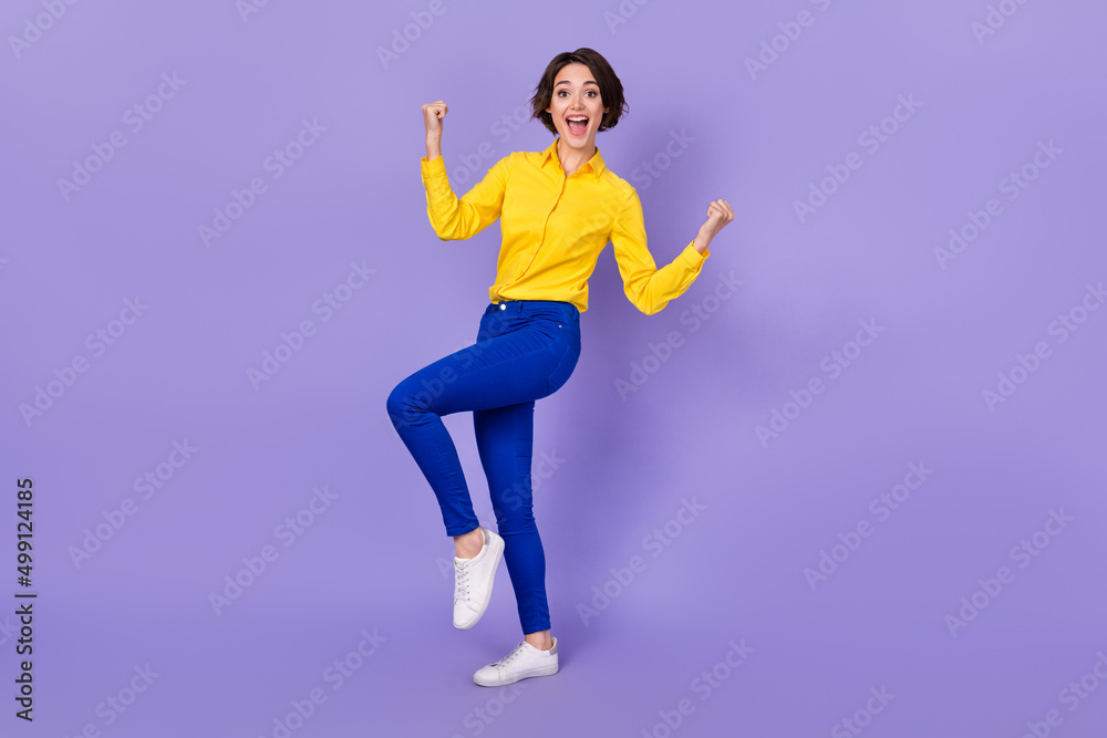 Full size photo of hooray millennial brunette lady yell wear shirt trousers sneakers isolated on purple color background Full size photo of hooray millennial brunette lady yell wear shirt trousers sneakers isolated on purple color background