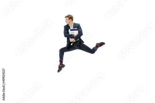 Young man in dark business suit jumping, flying isolated on white background. Art, motion, action, flexibility, inspiration concept. © master1305