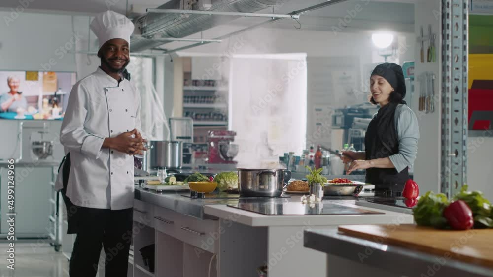POV of diverse team of people recording cooking show, explaining culinary recipe and making gourmet dish on camera. Man and woman filming authentic gastronomy video for TV program.