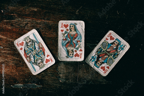 old playing cards for poker on a wooden table