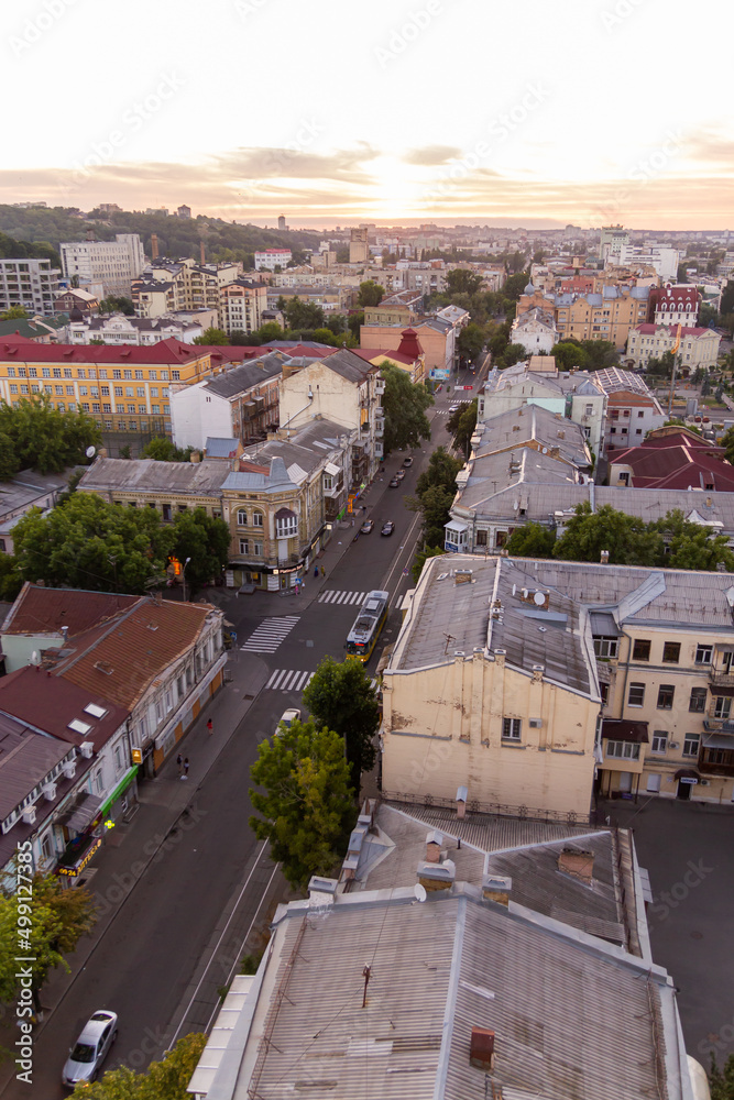 Fototapeta premium Ukraine, Kyiv – July 04, 2015: Aerial panoramic view on central and historical part, area of city Podil with residential buildings in the evening, during the sunset. Pre-revolutionary buildings