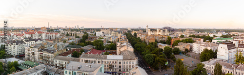 Ukraine, Kyiv – July 04, 2015: Aerial panoramic view on central and historical part, area of city Podil with residential buildings in the evening, during the sunset. Pre-revolutionary buildings © Bohdan