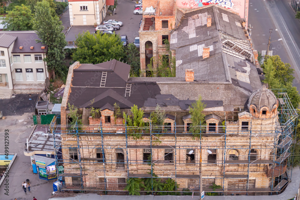 Obraz premium Ukraine, Kyiv – July 04, 2015: Aerial panoramic view on central and historical part, area of city Podil with residential buildings in the evening, during the sunset. Pre-revolutionary buildings