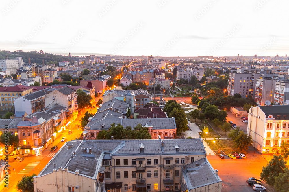 Ukraine, Kyiv – July 04, 2015: Aerial panoramic view on central and historical part, area of city Podil with residential buildings in the evening, during the sunset. Pre-revolutionary buildings